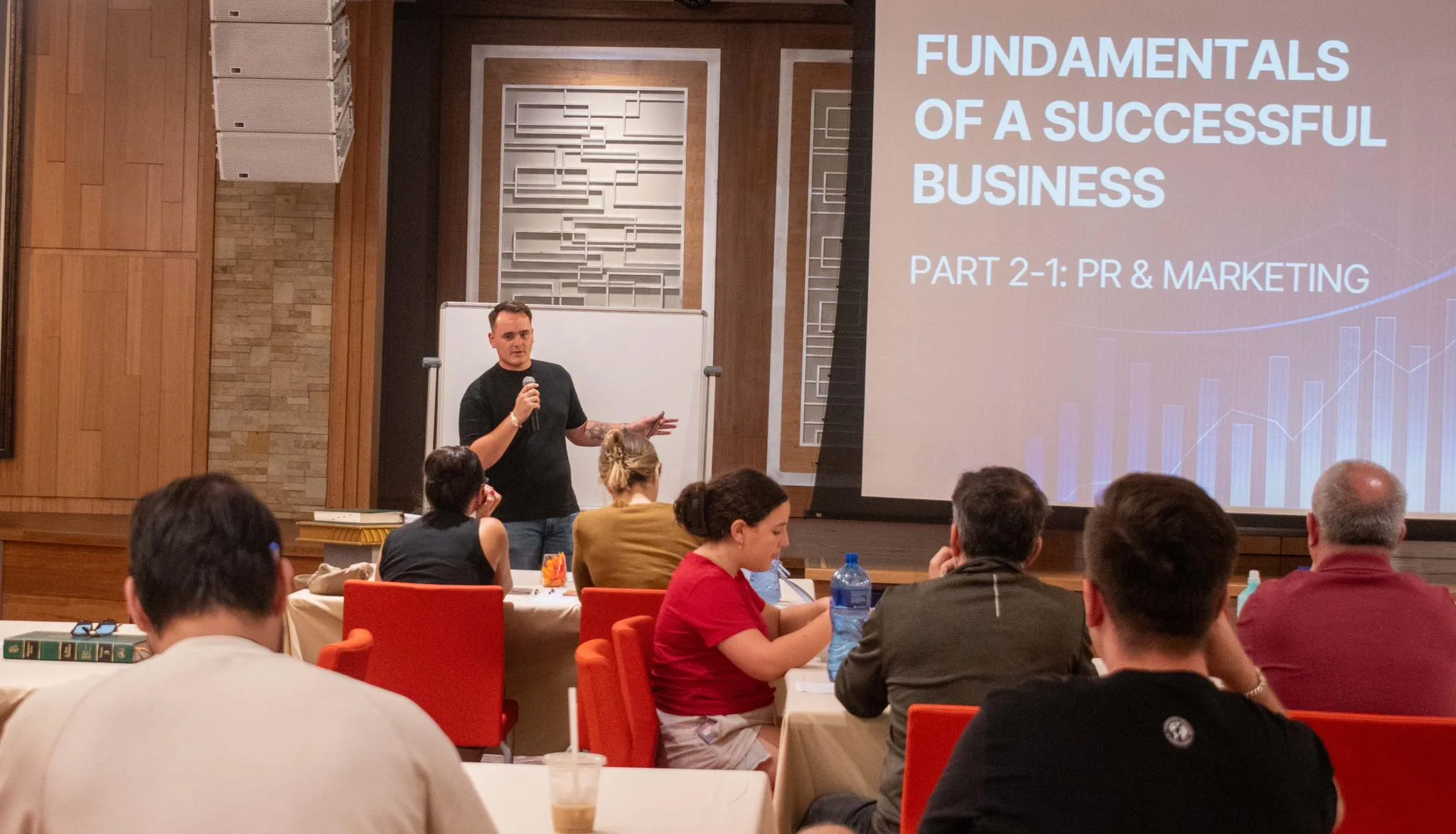 Devin speaking at a seminar